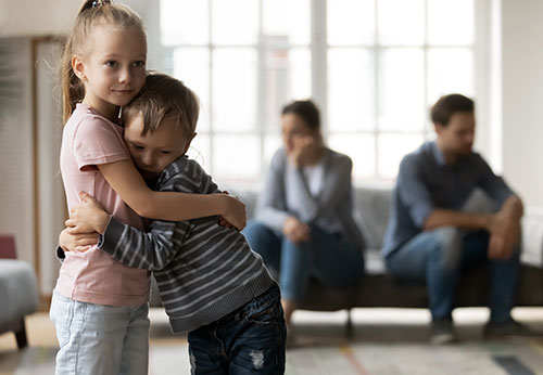 Sad children hugging during a family dispute; legal guidance for child custody law.